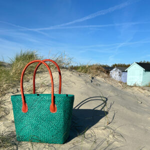 Camille tote bag in teal on sand dunes near beach huts