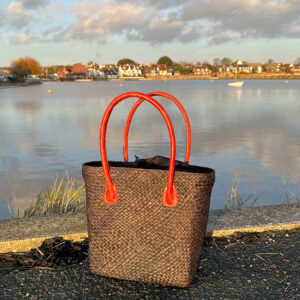 Camille raffia tote bag in black beside pond in Emsworth