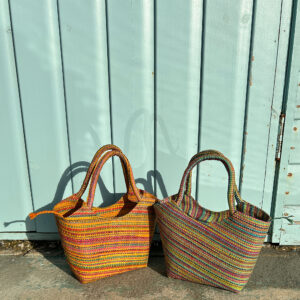 Lillie Handbag in multicolour yellow and multicolour mint beside beach hut
