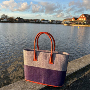 Monique raffia handbag in blues beside pond
