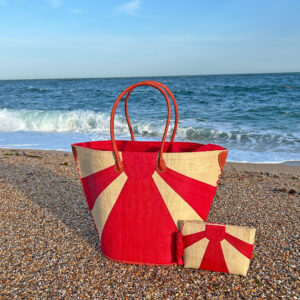 Sunburst Tote Bag and Sunburst Clutch Bag in red at beach